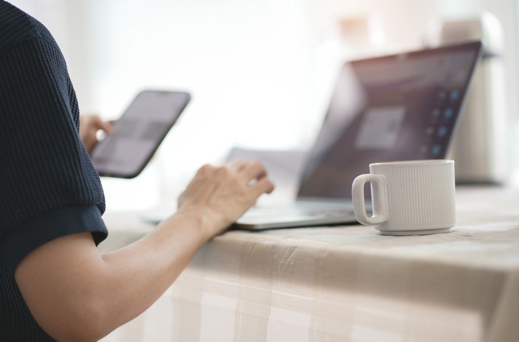 Man working remotely while drinking cup of coffee
